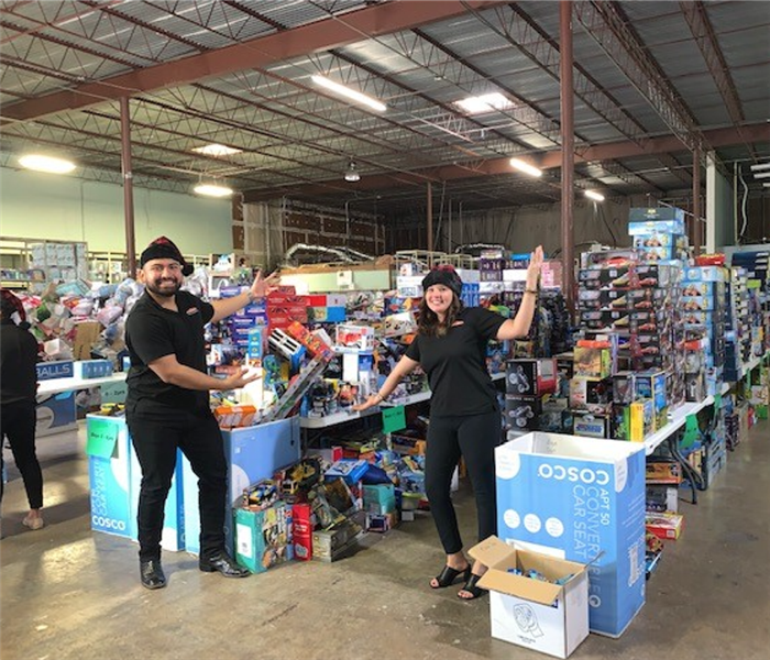 Two team members posing in front of toys.