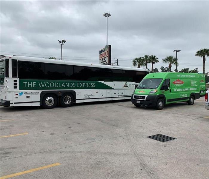 SERVPRO Van in front of a bus. 