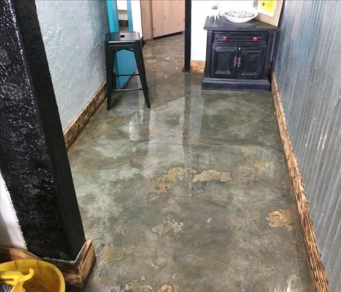 Standing water in a hallway.