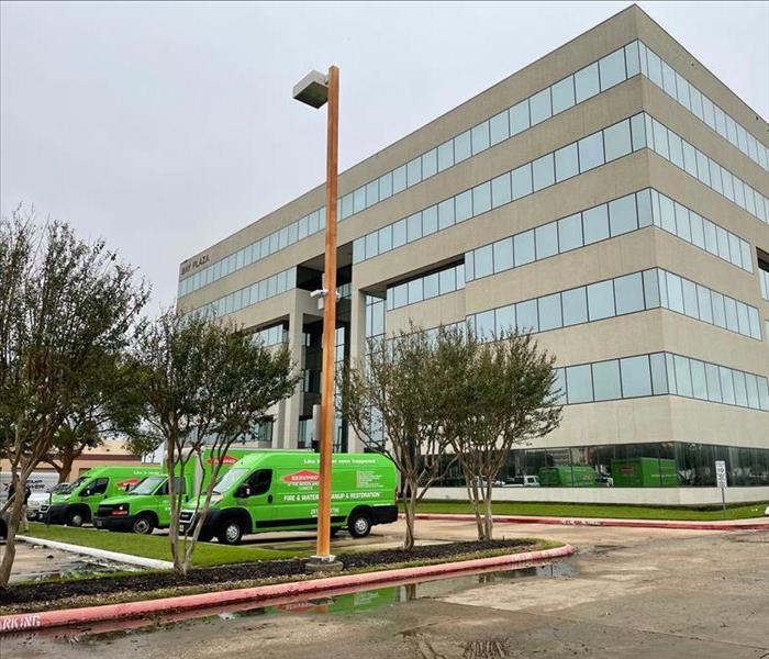 Green SERVPRO® vehicles on a commercial job site.