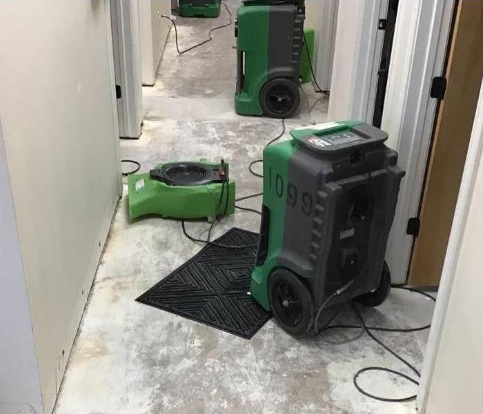 Drying equipment placed in the hallway of a building.